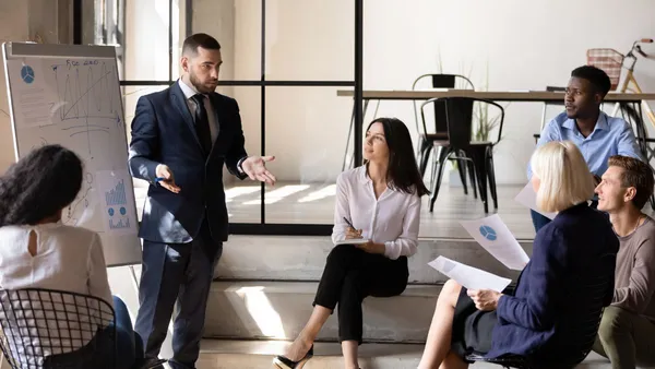 Executive confidently speaking during a spontaneous discussion